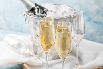 Bucket with ice and champagne on color background © Pixel-Shot