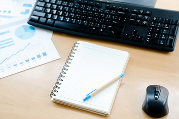 Close up Computer Keyboard and Mouse , Pencil and Graphing Notebook on Top of Wooden Desk