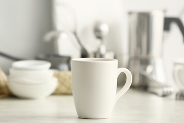 Blank cup on kitchen table