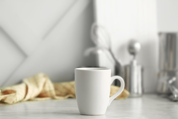 Blank cup on kitchen table