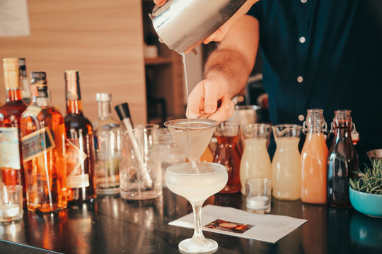 The Expert Bartender Is Making A Cocktail At The Bar. Man Preparing Cocktails.