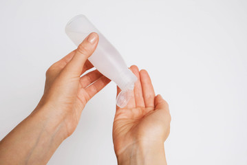 Woman disinfecting her hands using sanitaser antiseptic gel.