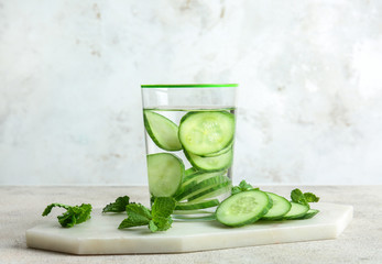 Glass of cucumber infused water on table