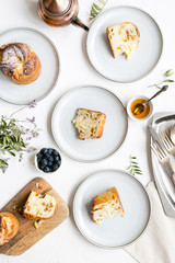 Table with plates and pieces of pies, tea, fresh berries. Family breakfast concept, top view
