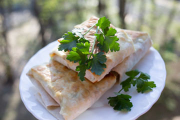 Pita with greens on a white plate, delicious Breakfast made at home. Traditional Middle Easter fast food. Homemade dish. 