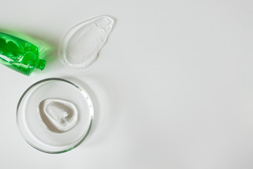 Aloe gel in glass petri dish on white background with copy space. Concept laboratory tests and research, making cosmetic. Purity facial cleanser, peeling, shampoo or shower gel