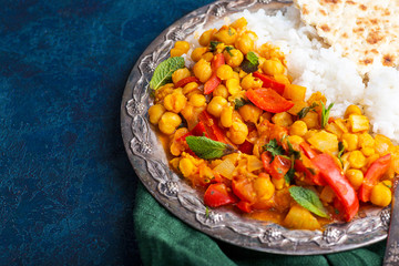 vegan food, rice, chickpeas with vegetables, pita bread on a blue background