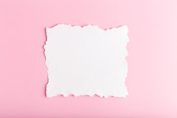 white blank with ragged edges on a pink background