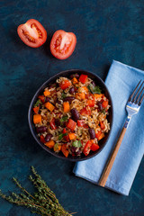 brown rice with vegetables on a blue background