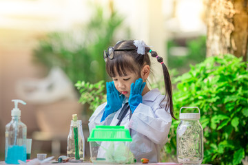 Fototapeta premium Close-up background view of a cute girl Who are learning science, business concepts, experimenting with chemical coloring or marketing planning