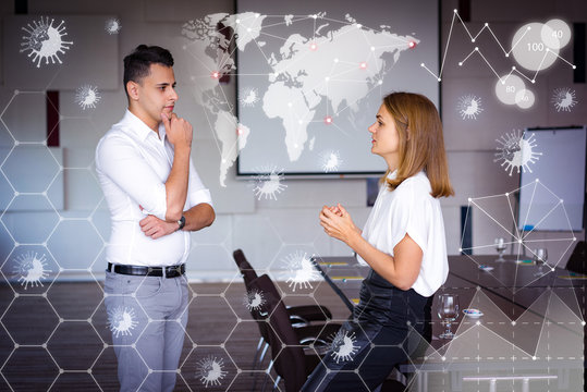 Man And Woman In Conference Hall And Virtual Pandemic Graphics. Young Caucasian Businesswoman Sitting On Table And Talking To Male Colleague. Business Relationship Concept