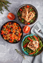 three vegan dishes on a grey concrete background, top view