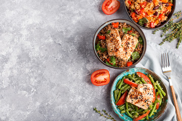three vegan dishes on a grey concrete background, top view