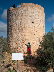 Woman gives hug defense tower torre de Cap Andritxol