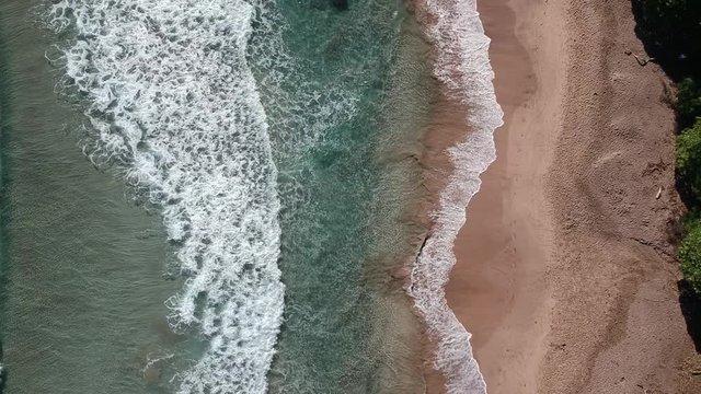 Birds eye view of the waves crashing on the shore at Koki beach in Hana, Maui