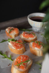 sandwich with red fish and arugula. Quick breakfast. Healthy Nutrition and Vitamins, Coffee and tea