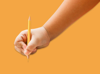 Children hand holding a yellow pencil on a isolated white background.