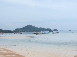 Boats on the shore against the background of the island