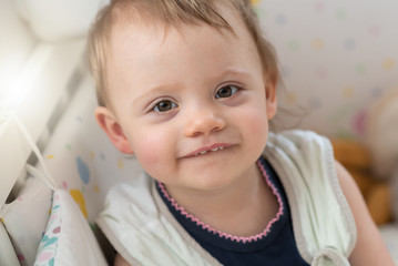 Portrait of baby girl in her bed