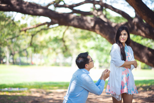 Man Pleading Woman At Park