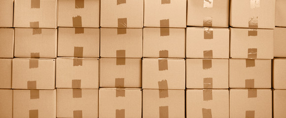 Cardboard boxes texture for delivery or moving. Stack of boxes and blue background