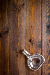 Empty bottle on wooden background top view copy space