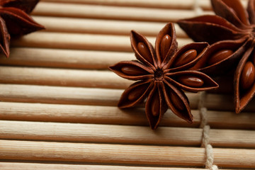 
spice star anise in good quality on a bamboo mat with free space for inscription and description