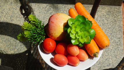 Tomatoes, carrots on the table glass