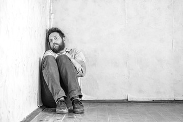 a crazy man with a beard hid in a corner in his old room