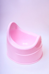 Toilet training chamber pot for small children. Potty pink on a white background.