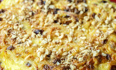 macaroni pudding with cheese, raisins, egg with hazelnuts on top macaroni pudding with cheese and egg with hazelnuts on top