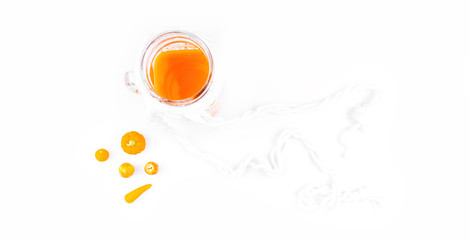 glass jar of carrot pumpkin juice on white background.