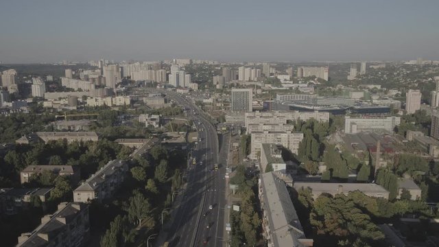 A large white building in a city. High quality footage D-log, S-log
