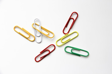 colorful paper clips on white background