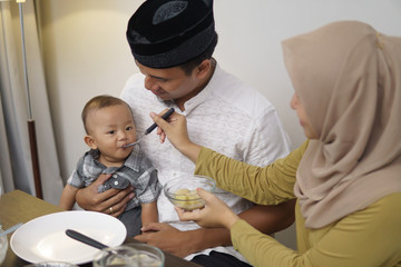family having early breakfast before dawn. sahoor or sahur on ramadan