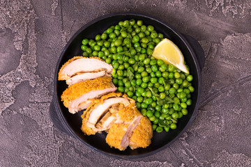 Chicken grilled fillet filled with julienne, lemon and steamed green pea. Healthy food, ketogenic diet. Keto/Paleo