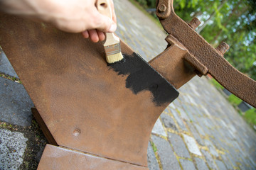 Restore old plough and paint with black paint