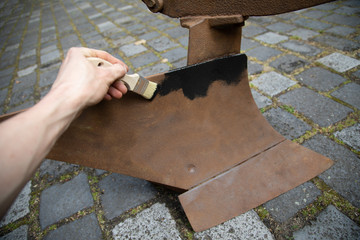 Restore old rusty agricultural machine and paint it with paint