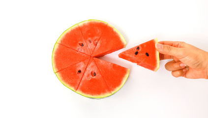 Woman  hand taking piece of slice red watermelon on white background