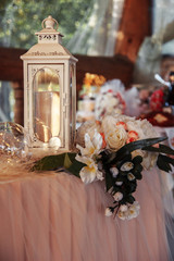 White lantern with candles on the table, wedding rustic decor