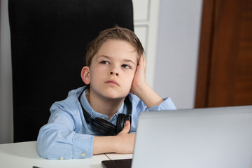 e-learning from home - lovely young boy working with his computer