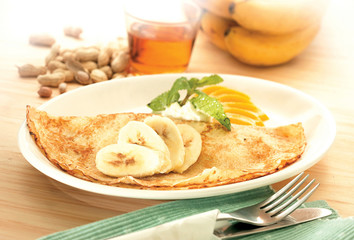 Crepe pancake with banana and peanut butter