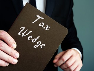 Tax Wedge  inscription on the piece of paper.