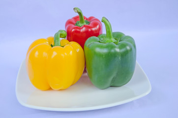 Three bell pepper in ceramic dish