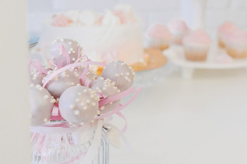 gently lilac cake pops on the plate.