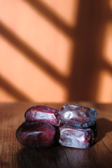 Dried dates with shadow  on wooden background.
