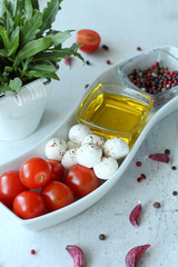 mozzarella tomatoes olive oil on a white plate