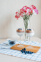Delicious and delicate creamy Italian dessert Panna Cotta made from chia seeds in milk and chocolate mass. Decorated with fresh blueberries and crumbs of milk chocolate. 