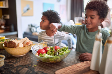 afro-american kids eating healthy food together. brother and sister. togetherness concept
