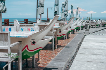 treet cafe with umbrellas and tables in sea dolphin lead